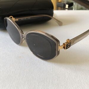 Chanel Gray Oval Sunglasses with CC lock logo on handles